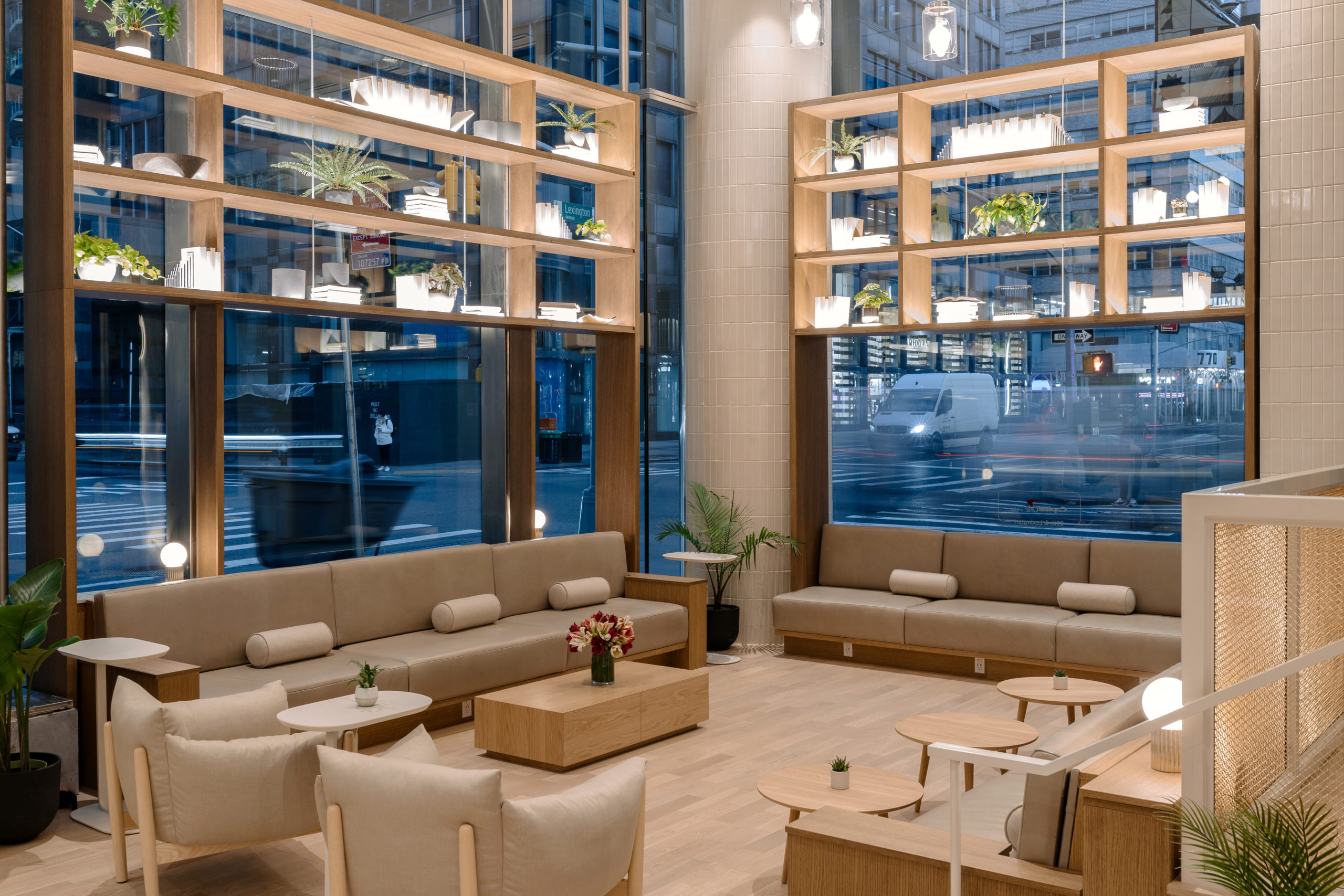 Showing the new café at 59th & Lexington in New York, with open modernistic interiors in cream and wood finishing. As well as ATMs and work spaces for consumers. 