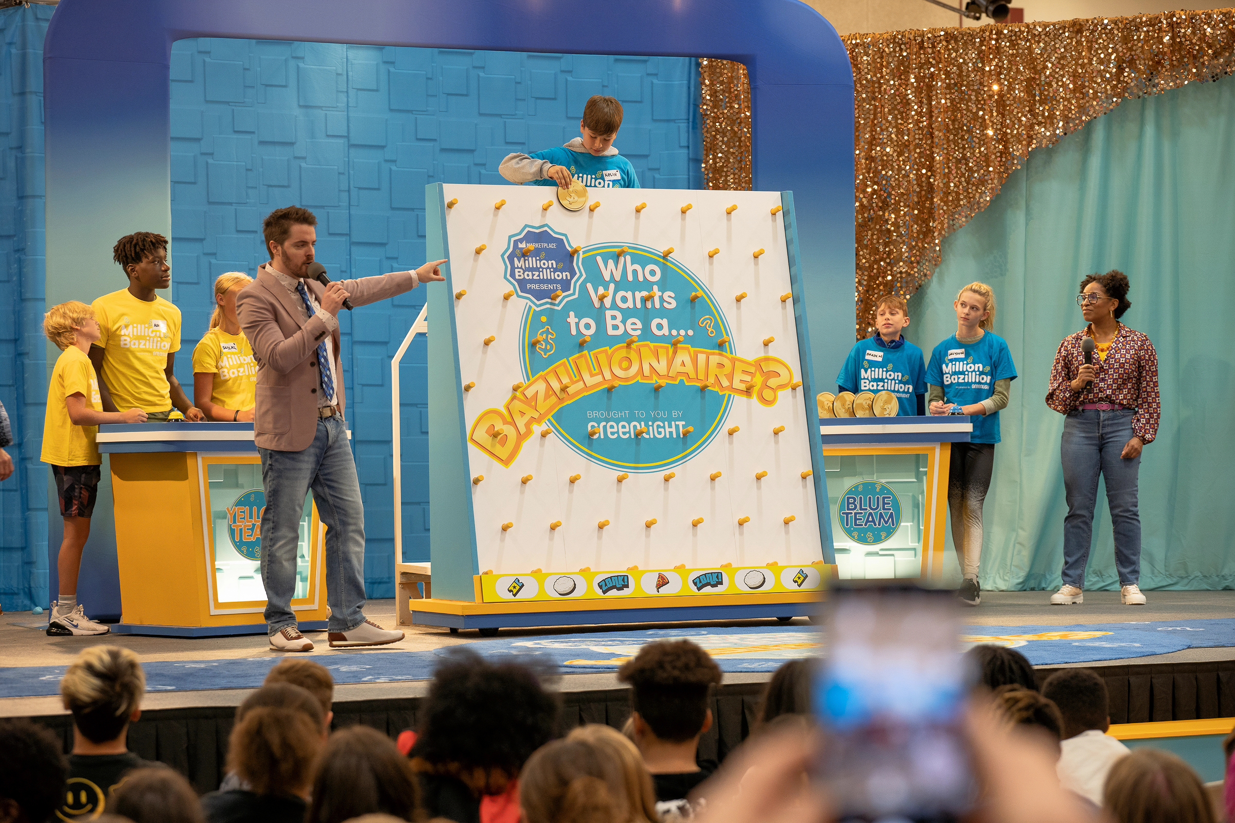 A picture of the game show, where a kid is playing on a large plinko board. 